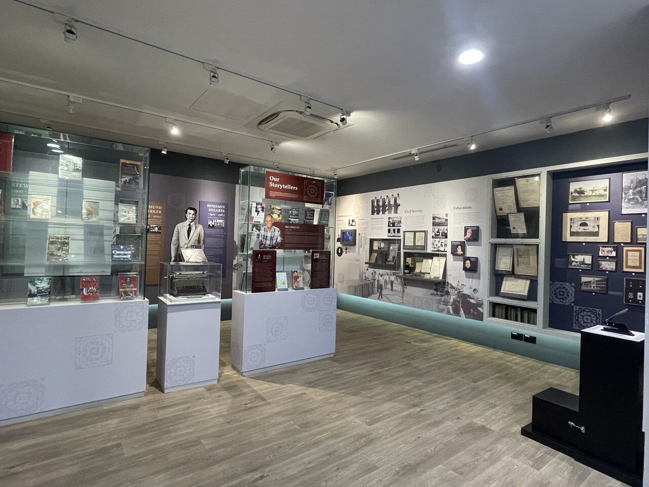 An exhibition room with wall panels and display cases on Eurasian heritage and history in Singapore.