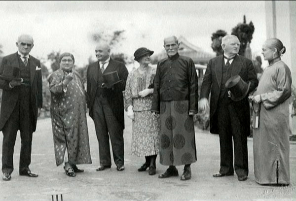 A group of men and women in formal and Chinese dress on a terrace, Hong Kong, about 1935.
