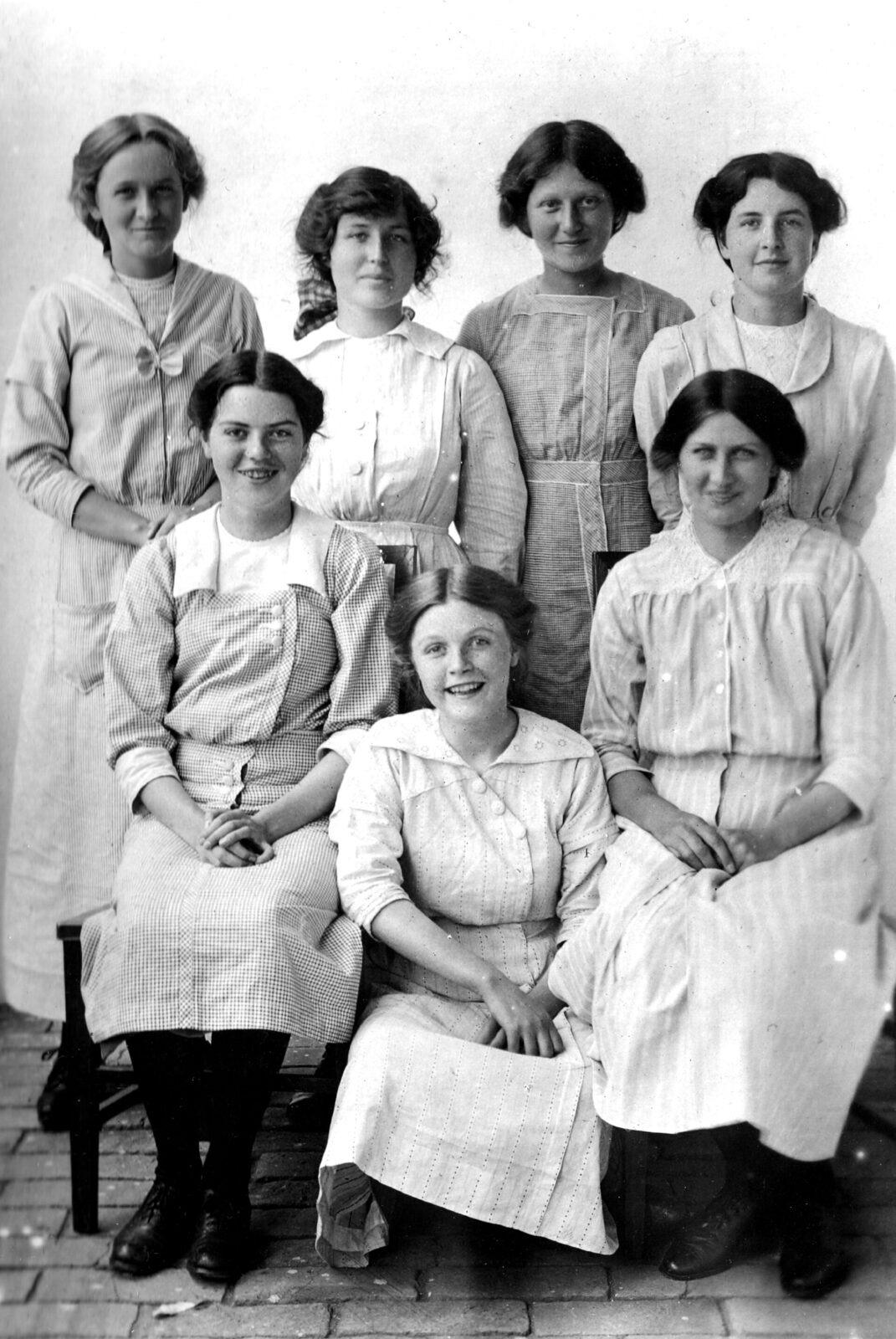 A formal group photograph of older girls in school dress at the Chefoo School in Shandong, China, around 1914.