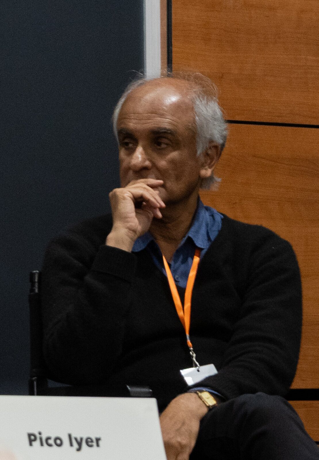 Pico Iyer seated at a panel table at the LA Book Fest in 2025, with his name card visible.
