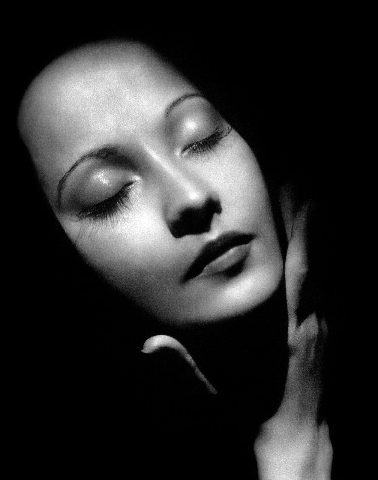 Studio portrait of the actress Merle Oberon in 1937, in profile with dark hair swept back.